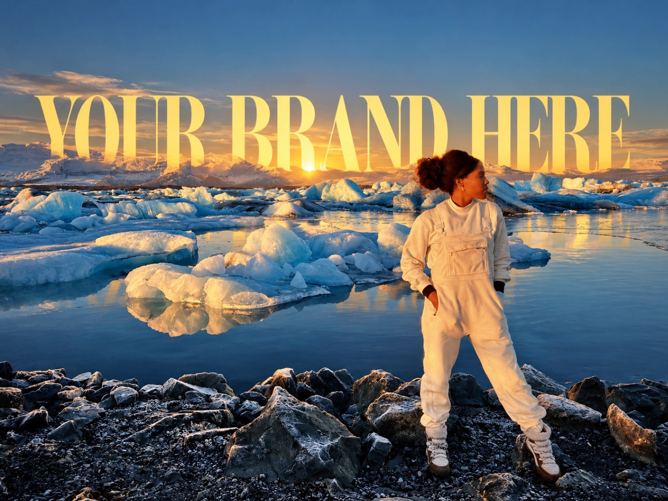 Sojourn Wallace standing at a glacial lagoon at golden hour with icebergs behind — 'Your brand here' treatment