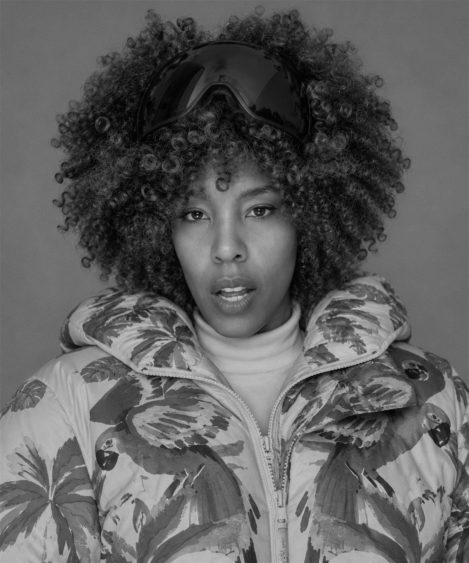 Sojourn Wallace in a tropical-print puffer jacket with goggles on her head